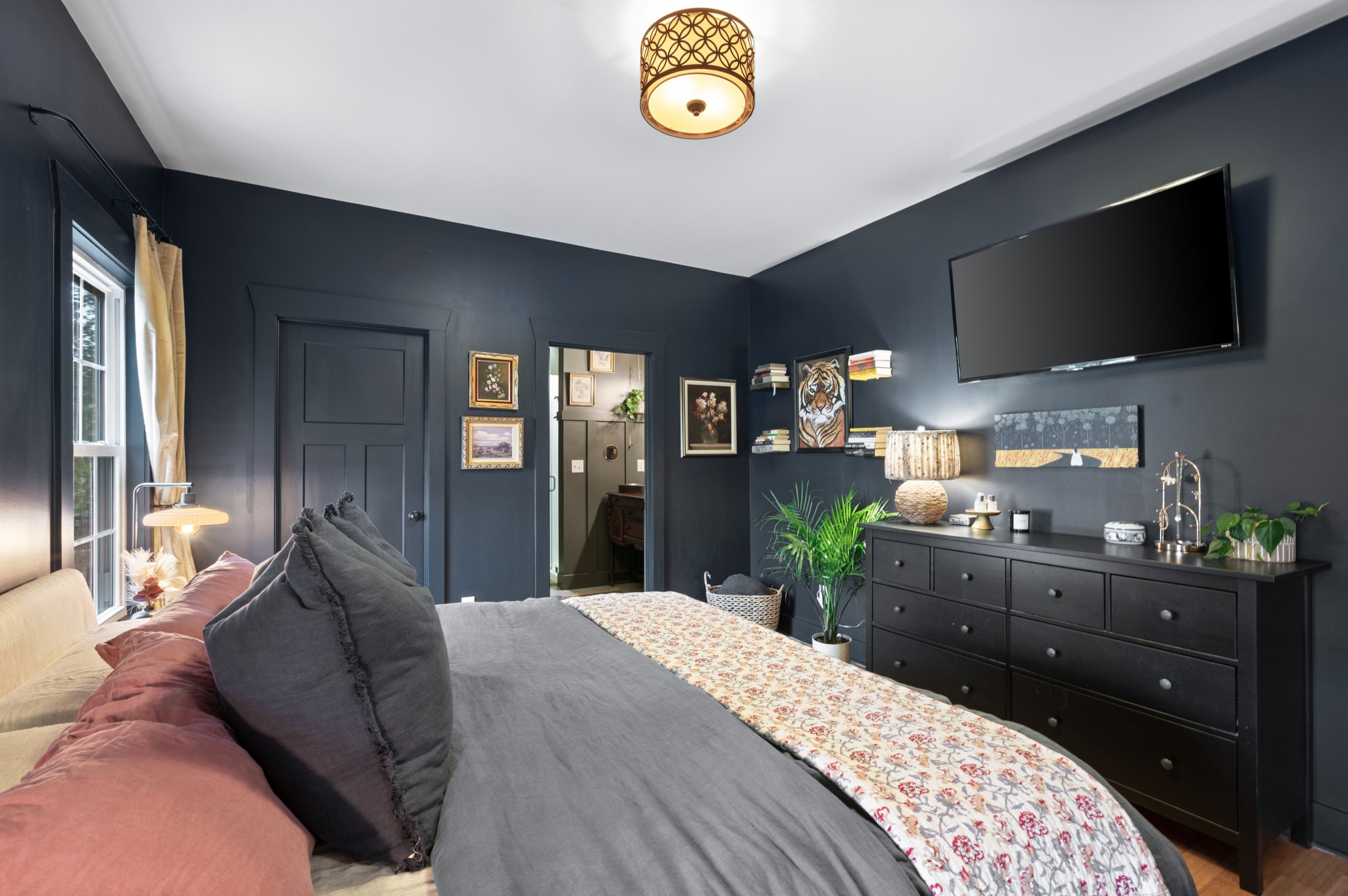 108 Poplar Street Dickson, TN 37055 - Photo 23 of 39 a large bedroom with a bed and a flat screen tv