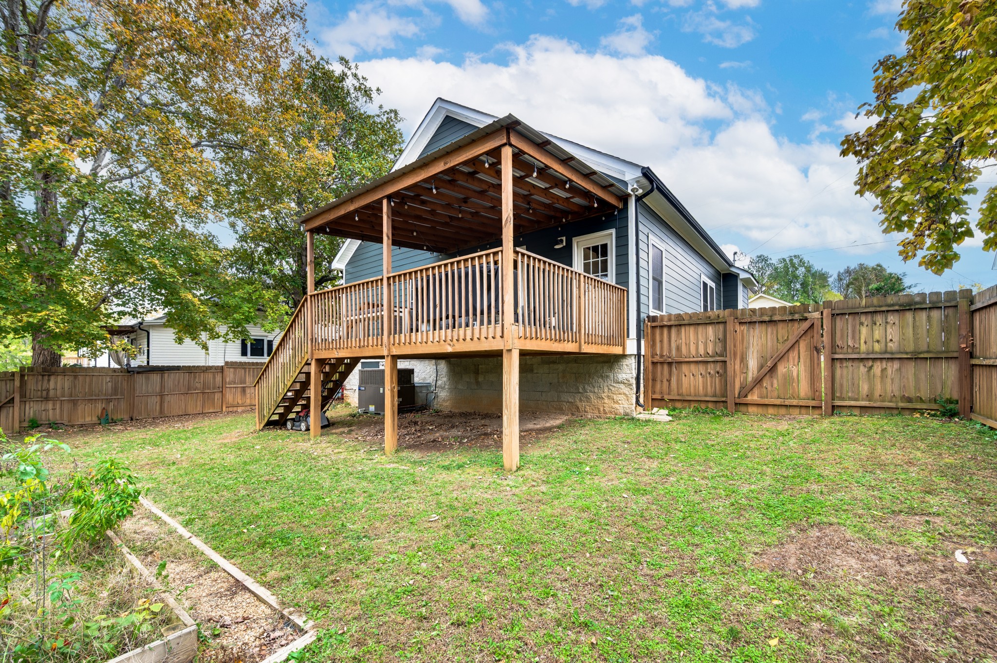108 Poplar Street Dickson, TN 37055 - Photo 36 of 39 a view of a house with a yard and wooden fence