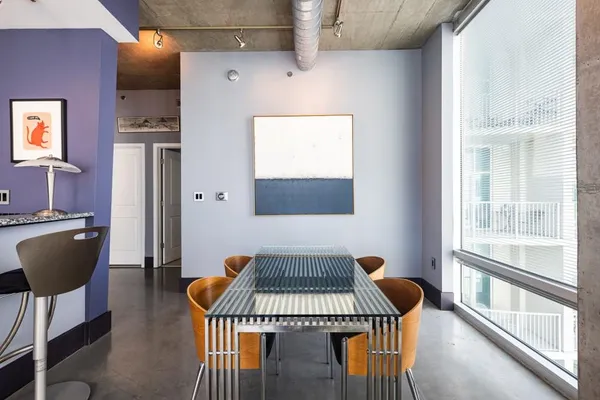 a dining room with furniture and wooden floor