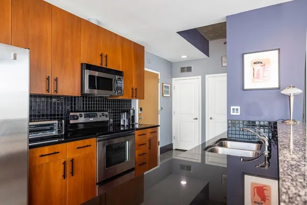 a kitchen with stainless steel appliances a stove sink and cabinets