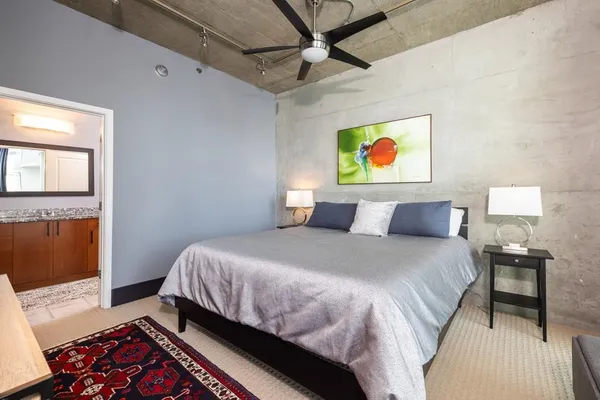 a bedroom with a bed and a window