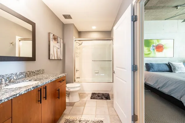 a utility room with wooden floor washer and dryer