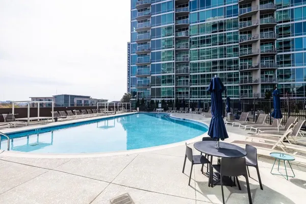 a view of swimming pool with outdoor seating and yard