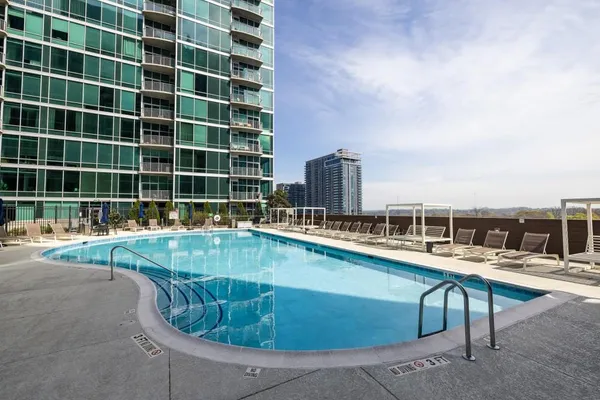 a view of a swimming pool with outdoor seating