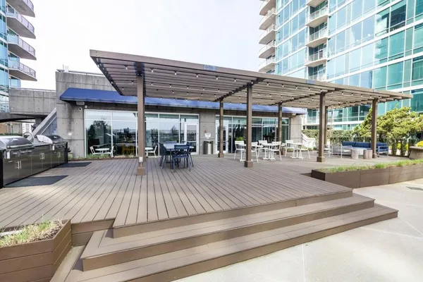 a view of a deck with dining table and chairs barbeque with wooden floor