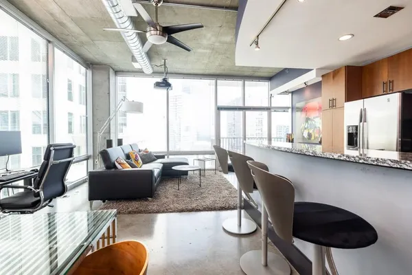 a living room with furniture and a large window