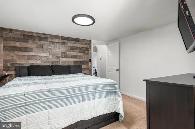 a bedroom with a bed and a fireplace