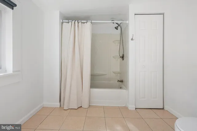 a bedroom with a large bed and a large window