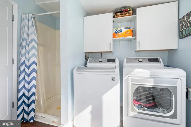 a view of a room with baby bed and a window