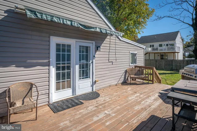 a view of a balcony with two chairs and wooden floor