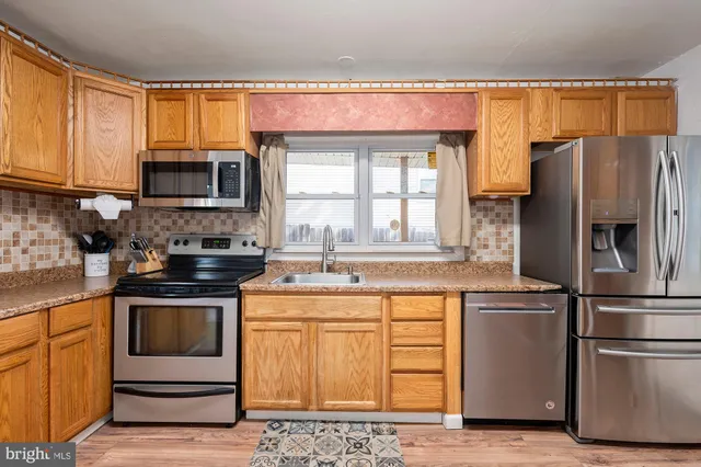 a kitchen with a refrigerator stove and microwave