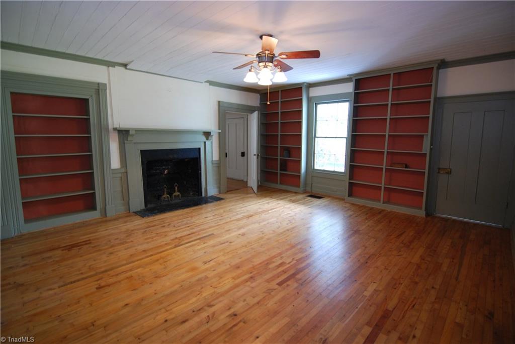 1036 Covington House Road Walnut Cove, NC 27052 - Photo 12 of 29 Living room - Notice the beautiful hard wood floors and built in book shelves.