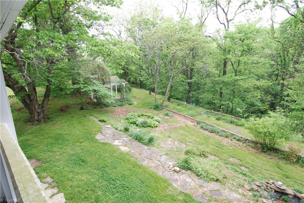 1036 Covington House Road Walnut Cove, NC 27052 - Photo 27 of 29 Another view of the backyard that shows the pergola, mature trees & beautiful stone work.