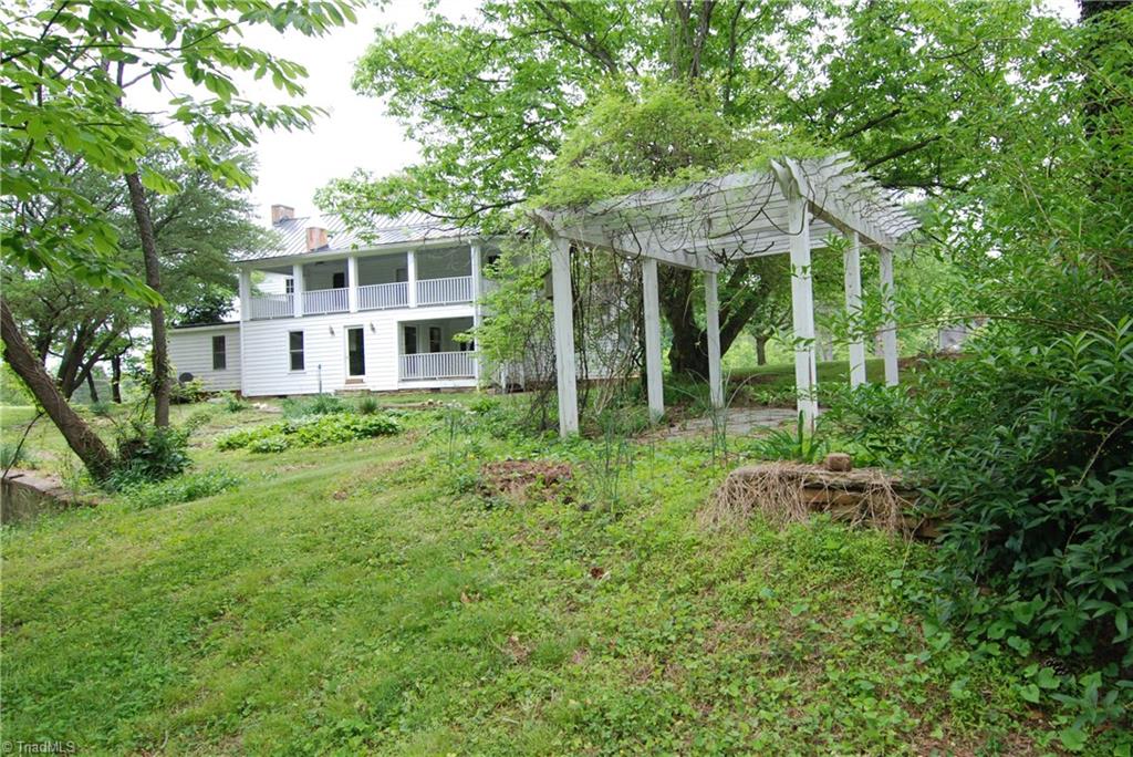 1036 Covington House Road Walnut Cove, NC 27052 - Photo 5 of 29 Beautiful pergola and stonework thought to be original to the home.