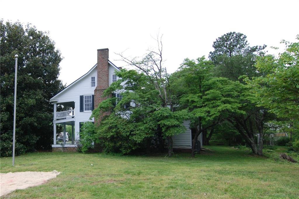 1036 Covington House Road Walnut Cove, NC 27052 - Photo 7 of 29 Side view of home showing mature trees and flag pole