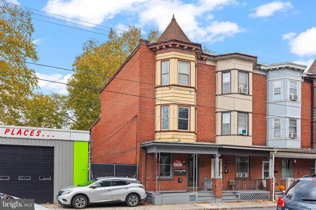 a front view of a building with parking