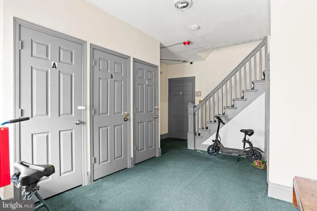 a view of a livingroom with stairs and furniture