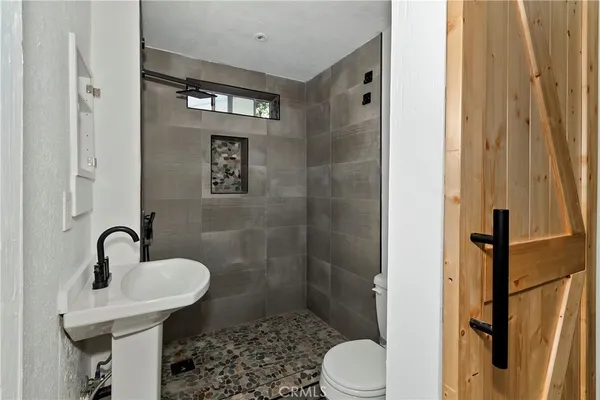 a bathroom with a sink toilet and shower