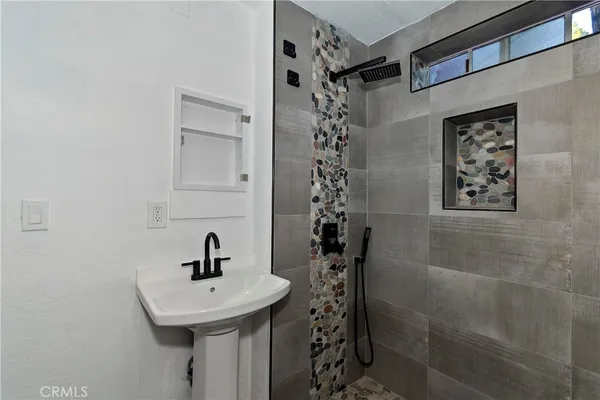 a bathroom with a sink a toilet and shower