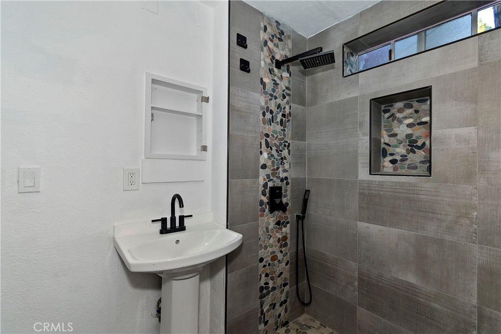 26331 Alpine Lane Twin Peaks, CA 92391 - Photo 12 of 41 a bathroom with a sink a toilet and shower