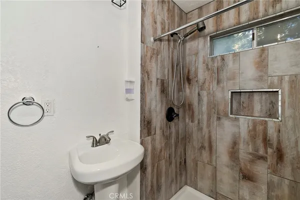 a bathroom with a sink a mirror and a shower