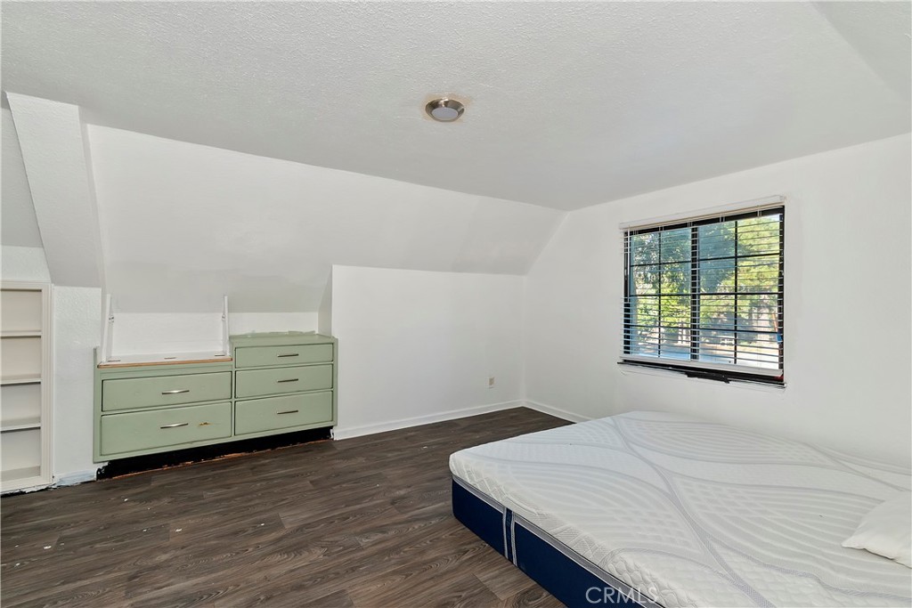 26331 Alpine Lane Twin Peaks, CA 92391 - Photo 16 of 41 a room with a bed and a dresser