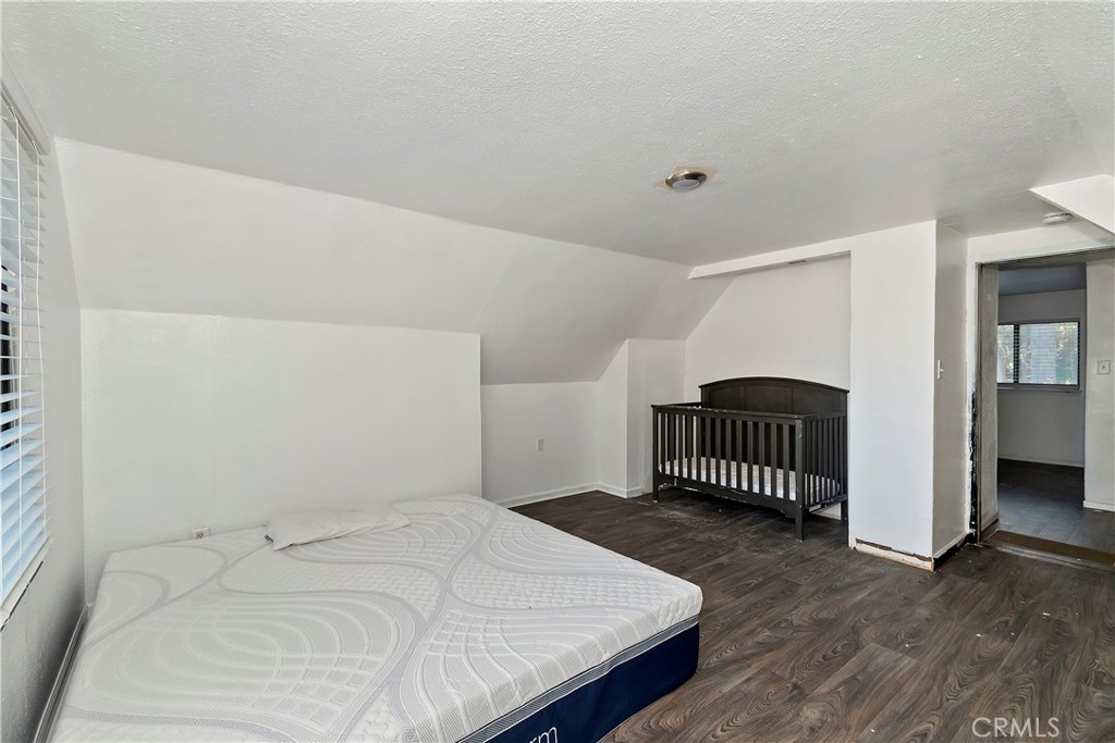 26331 Alpine Lane Twin Peaks, CA 92391 - Photo 17 of 41 a bedroom with a bed and a night stand