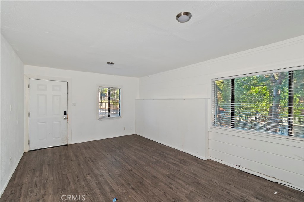 26331 Alpine Lane Twin Peaks, CA 92391 - Photo 19 of 41 a view of an empty room with wooden floor and a window