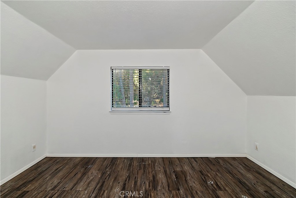 26331 Alpine Lane Twin Peaks, CA 92391 - Photo 21 of 41 an empty room with wooden floor and windows