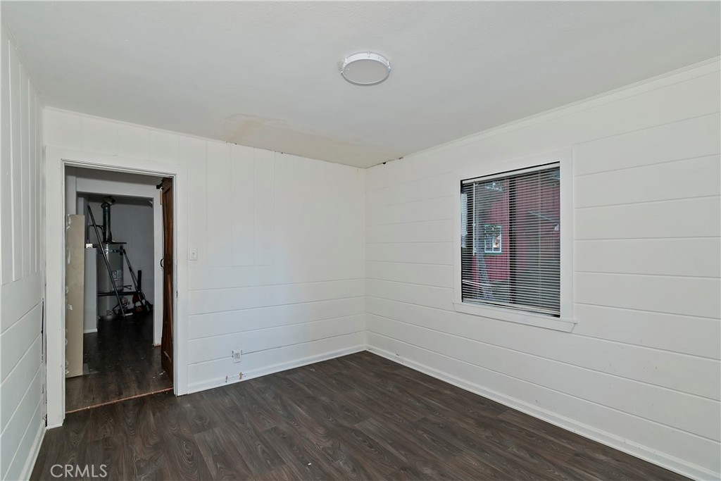 26331 Alpine Lane Twin Peaks, CA 92391 - Photo 27 of 41 a view of an empty room with wooden floor and a window