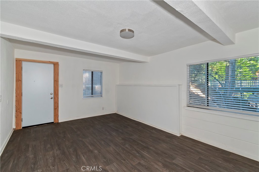 26331 Alpine Lane Twin Peaks, CA 92391 - Photo 32 of 41 a view of a big room with wooden floor and windows
