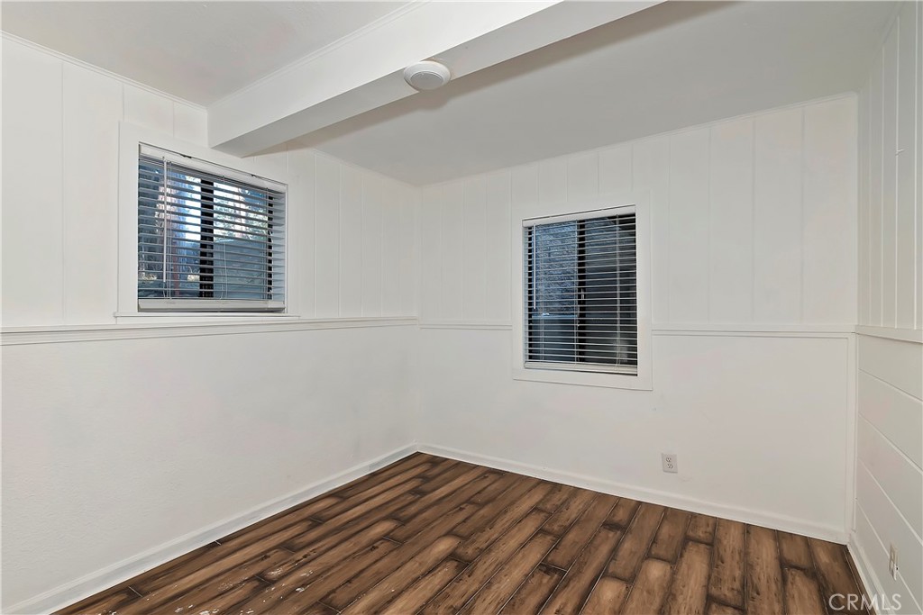 26331 Alpine Lane Twin Peaks, CA 92391 - Photo 35 of 41 a view of an empty room with wooden floor and a window