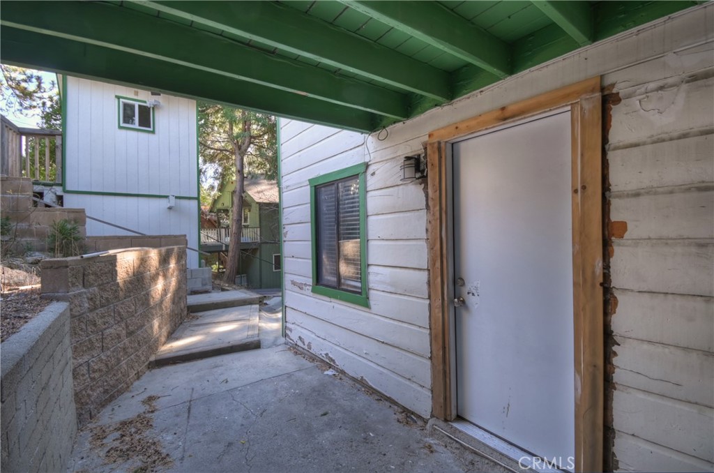 26331 Alpine Lane Twin Peaks, CA 92391 - Photo 36 of 41 a view of room with window and wooden door
