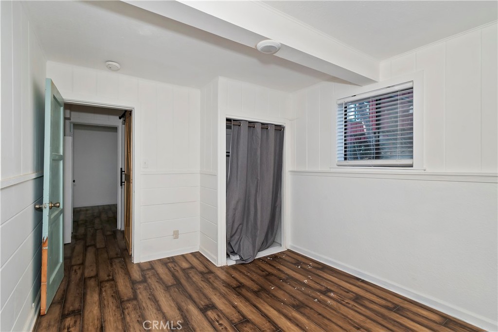 26331 Alpine Lane Twin Peaks, CA 92391 - Photo 37 of 41 a view of an empty room with wooden floor and a window