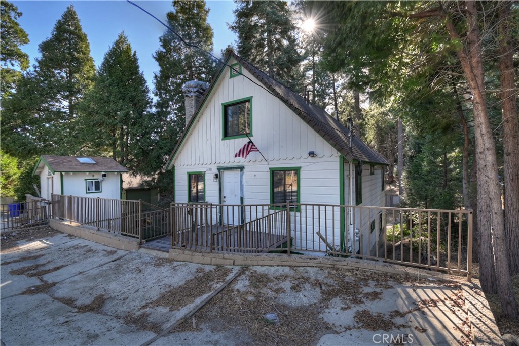 26331 Alpine Lane Twin Peaks, CA 92391 - Photo 41 of 41 a view of a wooden house with a small yard and wooden fence