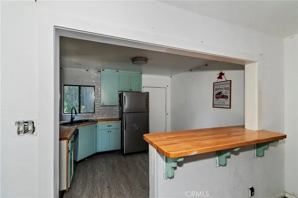 a kitchen with stainless steel appliances granite countertop a stove refrigerator and sink
