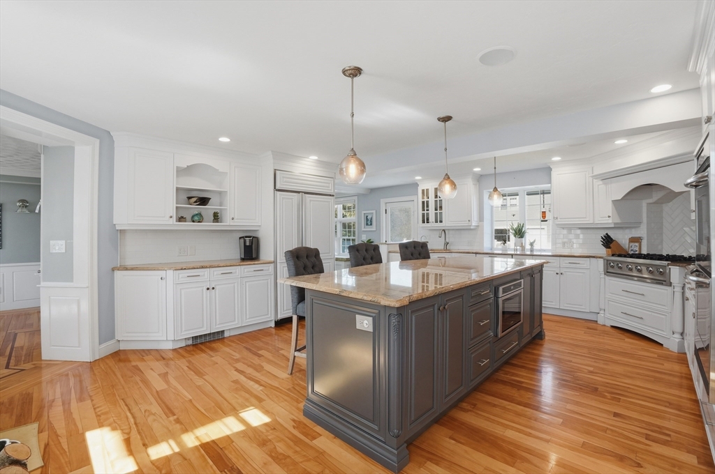 183 Whiting Street Hanover, MA 02339 - Photo 7 of 42 a kitchen with stainless steel appliances granite countertop a sink a stove and a refrigerator