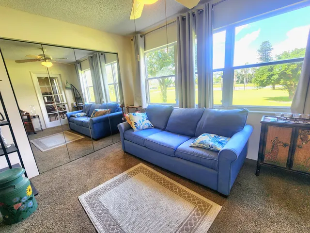 a bedroom with a bed and ceiling fan