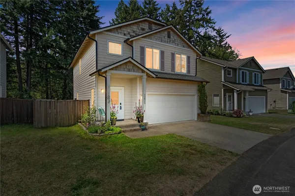 a front view of a house with a yard and garage