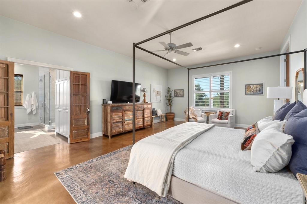 2300 West Fitzhugh Road Dripping Springs, TX 78620 - Photo 21 of 39 a bedroom with a bed window and a television