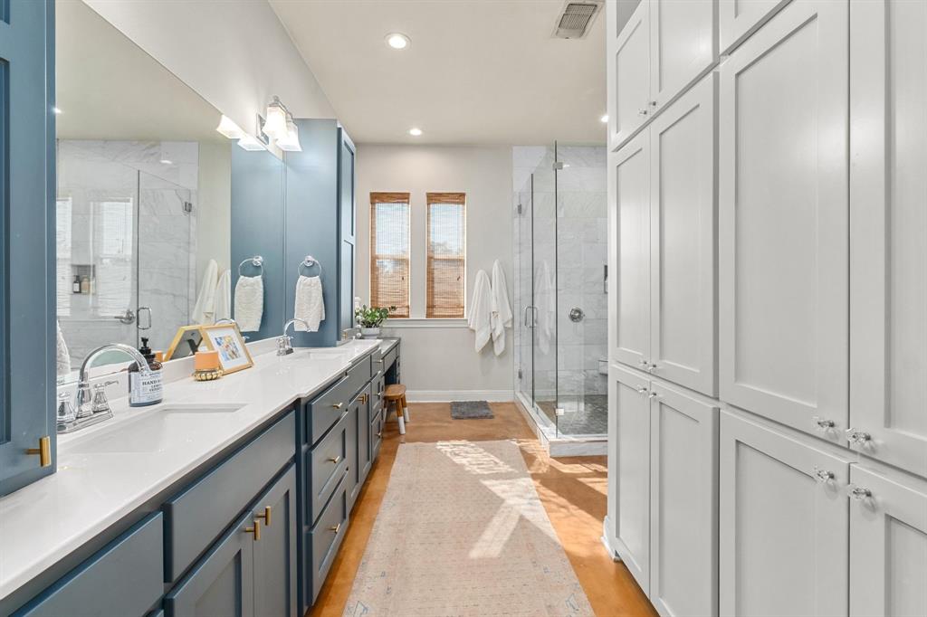 2300 West Fitzhugh Road Dripping Springs, TX 78620 - Photo 22 of 39 a bathroom with a double vanity sink and mirror with shower