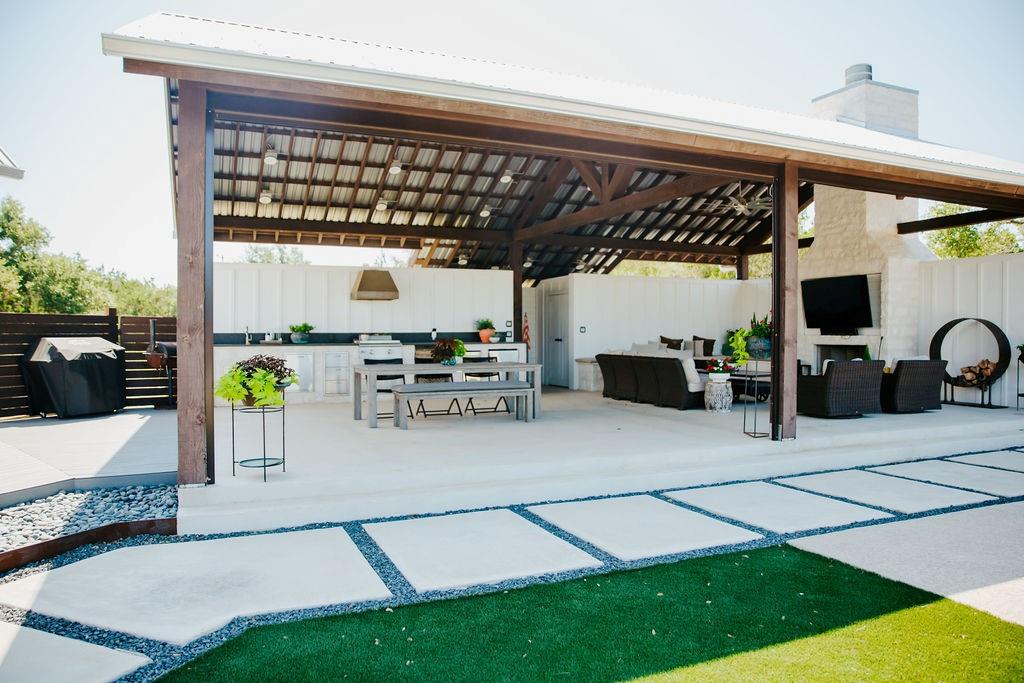 2300 West Fitzhugh Road Dripping Springs, TX 78620 - Photo 9 of 39 a view of a patio with table and chairs potted plants with wooden floor