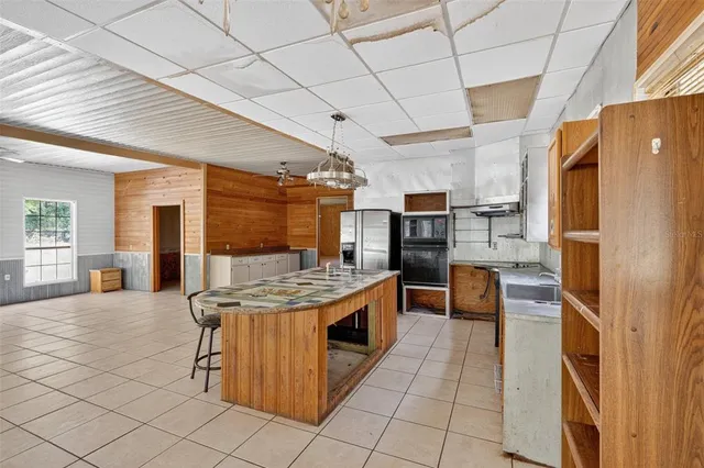 a kitchen that has a table and chairs in it