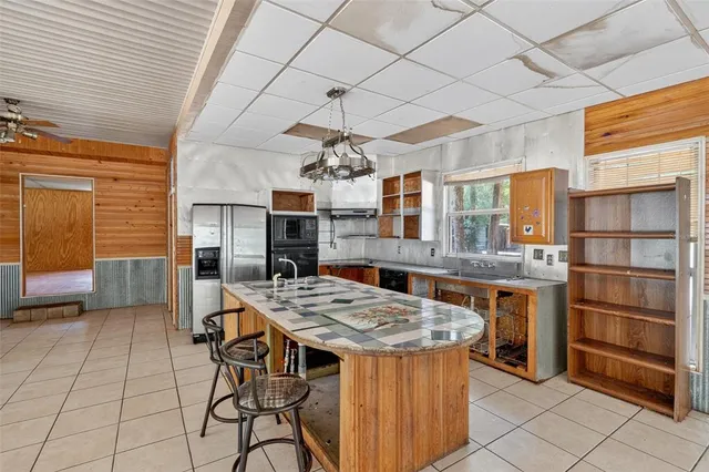 a very nice looking dining room with a large window and chandelier