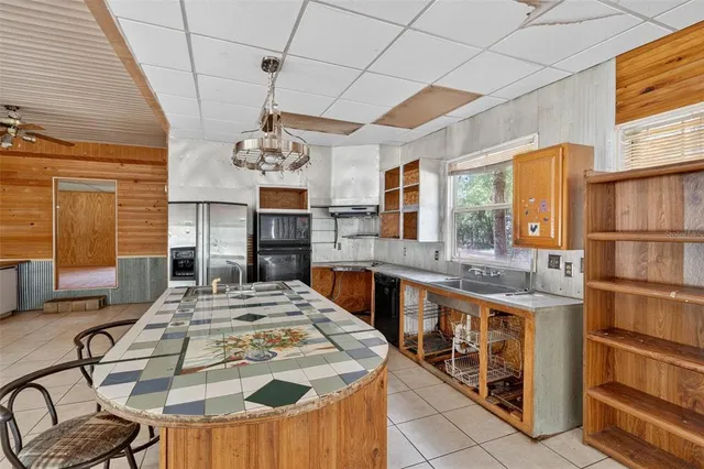a view of a dining room with furniture chandelier and window
