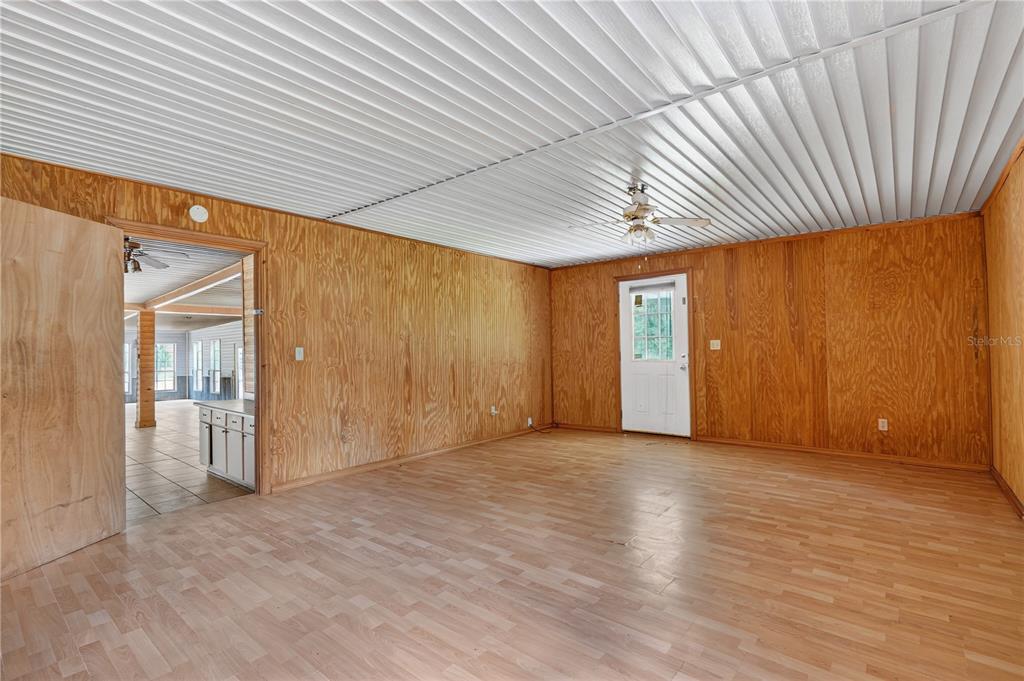 3749 Southwest 22nd Place Bell, FL 32619 - Photo 27 of 43 an empty room with wooden floor and natural light