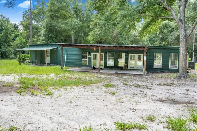 a view of a house with backyard and porch