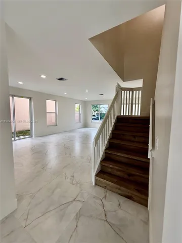 a view of staircase with white walls