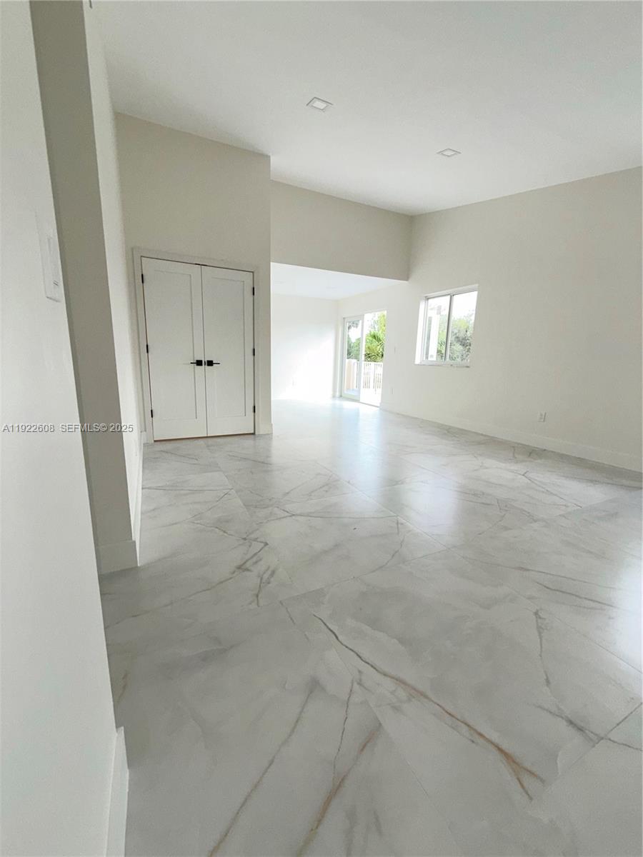 15254 Southwest 109th Street Miami, FL 33196 - Photo 13 of 48 an empty room with windows and yard