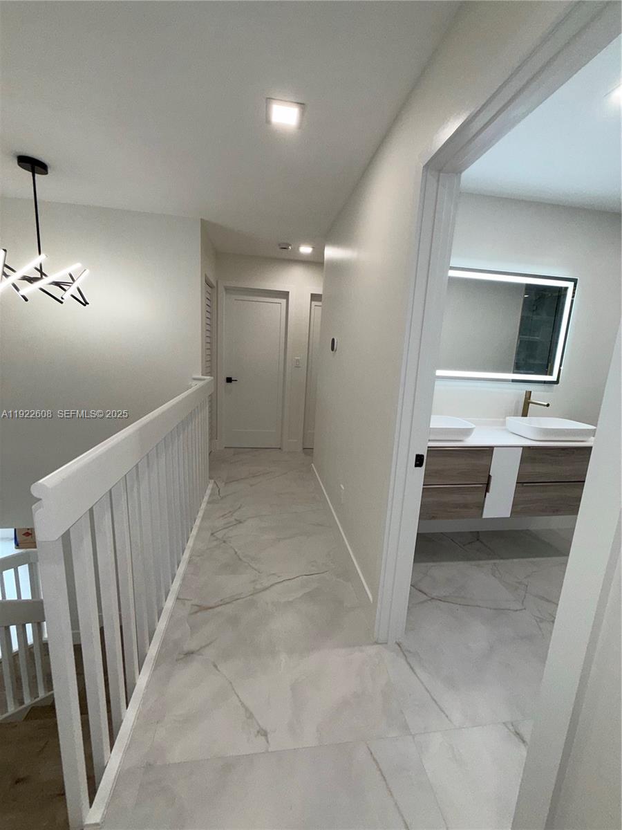 15254 Southwest 109th Street Miami, FL 33196 - Photo 31 of 48 a view of a hallway with workspace